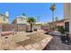 Backyard features a hammock, mature landscaping, and a block wall at 6058 Grape Blossom Ave, Las Vegas, NV 89142