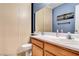 Well-lit bathroom featuring a vanity with a large mirror and ample storage at 6058 Grape Blossom Ave, Las Vegas, NV 89142