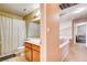 Bathroom featuring a shower with curtain and vanity, adjacent to a hallway with railing at 6058 Grape Blossom Ave, Las Vegas, NV 89142
