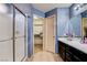 Bathroom with a shower, double sinks, and a convenient walk-in closet at 6058 Grape Blossom Ave, Las Vegas, NV 89142