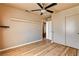 Well-lit bedroom with ceiling fan, wood floors, and closet for ample storage at 6058 Grape Blossom Ave, Las Vegas, NV 89142