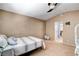 Comfortable bedroom with a ceiling fan, carpeted floors, and an ensuite bathroom at 6058 Grape Blossom Ave, Las Vegas, NV 89142