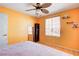 Inviting bedroom with hardwood floors, ceiling fan, and bright-colored walls at 6058 Grape Blossom Ave, Las Vegas, NV 89142