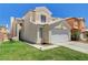 Charming two-story home with a well-maintained lawn, a two car garage and desert landscaping at 6058 Grape Blossom Ave, Las Vegas, NV 89142