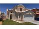 Charming two-story home featuring a tan stucco exterior, tile roof, and an attached two-car garage in a well-maintained neighborhood at 6058 Grape Blossom Ave, Las Vegas, NV 89142