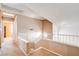 Upstairs hallway with neutral tones, a staircase, and interior windows at 6058 Grape Blossom Ave, Las Vegas, NV 89142