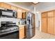 Kitchen featuring stainless steel appliances, plenty of cabinets and tile floors at 6058 Grape Blossom Ave, Las Vegas, NV 89142