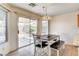 Eat-in kitchen, featuring access to the backyard, a cozy dining area, and tile floors at 6058 Grape Blossom Ave, Las Vegas, NV 89142