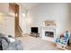 Comfortable living room with a fireplace and staircase leading to the upper level at 6058 Grape Blossom Ave, Las Vegas, NV 89142