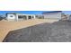 View of large backyard space next to the house and a detached garage at 6075 Dapple Gray Rd, Las Vegas, NV 89149