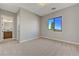 Neutral bedroom with a window view and ensuite bathroom entrance at 6075 Dapple Gray Rd, Las Vegas, NV 89149