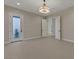 Bedroom with a modern light fixture and many doors for closets or rooms at 6075 Dapple Gray Rd, Las Vegas, NV 89149