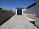 Paved driveway leading to a modern garage and home exterior, set against a clear blue sky at 6075 Dapple Gray Rd, Las Vegas, NV 89149