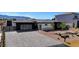 Striking single-story home with modern architecture, desert landscaping, and a beautiful paved driveway at 6075 Dapple Gray Rd, Las Vegas, NV 89149