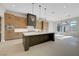 Open kitchen with central island, stainless appliances, and modern light fixtures and cabinetry at 6075 Dapple Gray Rd, Las Vegas, NV 89149