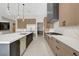 Open kitchen with island, stainless appliances, and light and dark wooden cabinetry at 6075 Dapple Gray Rd, Las Vegas, NV 89149