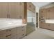 Close up of a kitchen with white countertops and backsplash, and stainless steel refrigerator at 6075 Dapple Gray Rd, Las Vegas, NV 89149
