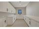 Bright laundry room with white cabinets, a countertop, and modern design at 6075 Dapple Gray Rd, Las Vegas, NV 89149