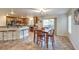 Eat-in kitchen with granite counters, wooden cabinets, and stainless steel barstools at 6546 American Flower St, Las Vegas, NV 89148