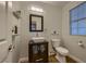 Charming bathroom featuring a vessel sink, stylish vanity and decorative shelving at 672 Solitude Point Ave, Henderson, NV 89012