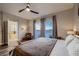 Bright bedroom featuring a ceiling fan and large windows overlooking mountains at 672 Solitude Point Ave, Henderson, NV 89012