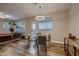 Bright dining space with a round table, modern lighting, and hardwood floors at 672 Solitude Point Ave, Henderson, NV 89012