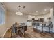 Cozy dining area with modern lighting, a glass-top table, and access to the kitchen at 672 Solitude Point Ave, Henderson, NV 89012
