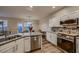 Modern kitchen featuring granite counters, stainless appliances, and natural light at 672 Solitude Point Ave, Henderson, NV 89012