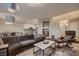 Open-concept living room adjacent to the kitchen with modern decor and hardwood floors at 672 Solitude Point Ave, Henderson, NV 89012