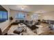 Spacious living room featuring modern furniture, a large rug, and ample natural light at 672 Solitude Point Ave, Henderson, NV 89012