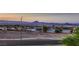Street view showcasing the surrounding neighborhood and landscape with beautiful sky and mountain views at 672 Solitude Point Ave, Henderson, NV 89012
