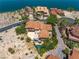Stunning aerial view of a lakeside home with a terracotta roof, backyard pool, and lush landscaping at 7 Rue Promenade Way, Henderson, NV 89011