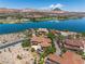 Striking aerial view showcases tile roofs with desert and lakeside neighborhood at 7 Rue Promenade Way, Henderson, NV 89011