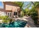 Beautiful pool and patio area, surrounded by lush landscaping and mature trees at 7 Rue Promenade Way, Henderson, NV 89011