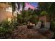Relaxing backyard patio features a stone fire pit, grill, lounge chairs, and lush landscaping at 7 Rue Promenade Way, Henderson, NV 89011