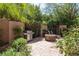 Private backyard oasis featuring a built in firepit, outdoor grill, and well-manicured landscape at 7 Rue Promenade Way, Henderson, NV 89011