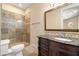 Bathroom features granite vanity and stone shower with glass door at 7 Rue Promenade Way, Henderson, NV 89011
