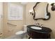 Charming powder room with marble countertop, ornate mirror, and decorative sconces at 7 Rue Promenade Way, Henderson, NV 89011