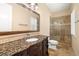 Bathroom features granite vanity and stone shower with glass door at 7 Rue Promenade Way, Henderson, NV 89011