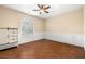 Neutral bedroom with hardwood floors, fan, window and custom molding at 7 Rue Promenade Way, Henderson, NV 89011