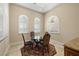 Elegant breakfast nook features a glass table, four chairs, and ample natural light from shuttered windows at 7 Rue Promenade Way, Henderson, NV 89011