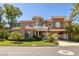 Charming two-story house featuring porte-cochere, manicured lawn, and lush landscaping at 7 Rue Promenade Way, Henderson, NV 89011