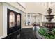 Grand foyer boasts a water fountain, marble floors, and double doors at 7 Rue Promenade Way, Henderson, NV 89011