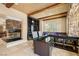 Inviting game room showcasing a fireplace, wet bar, and pool table with stone accent wall at 7 Rue Promenade Way, Henderson, NV 89011