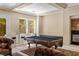 Spacious game room features a pool table, wet bar, and natural light from the windows overlooking the yard at 7 Rue Promenade Way, Henderson, NV 89011