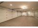 Spacious three car garage with tile floors, storage cabinets, and multiple doors offering ample room for vehicles and storage at 7 Rue Promenade Way, Henderson, NV 89011