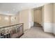 Upstairs hallway with wrought iron railing and views to the living room below at 7 Rue Promenade Way, Henderson, NV 89011