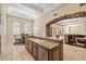 Open concept design connects kitchen with granite counters, a large island, stainless appliances, and a cozy dining area at 7 Rue Promenade Way, Henderson, NV 89011