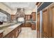 Custom kitchen with granite countertops, a stone hood, stainless steel appliances, and integrated high end refrigerator at 7 Rue Promenade Way, Henderson, NV 89011