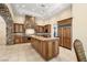 Spacious kitchen boasts custom cabinets, large island, granite countertops, and stone oven hood at 7 Rue Promenade Way, Henderson, NV 89011